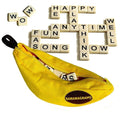 A yellow, banana-shaped pouch labeled "Bananagrams" from Planet Fun lies open with letter tiles spilling out. Some of the tiles are arranged above in a crossword puzzle form, displaying words like "HAPPY," "PLAY," "TIME," and "FUN." Loose tiles spell “WOW” and “FAS.” It's the perfect word game for family fun.