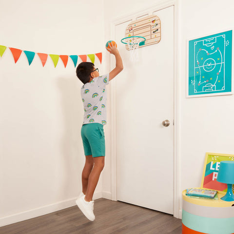Child playing with the B. toys Over-the-Door Basketball Hoop