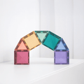 Colorful magnetic building blocks arranged in an arch on a white surface with a white background