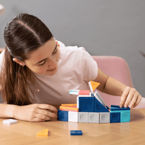 Woman playing with colorful building blocks on a table