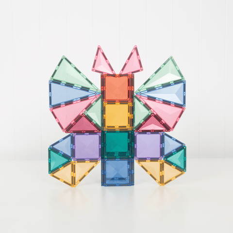 Child building with Connetix pastel magnetic tiles