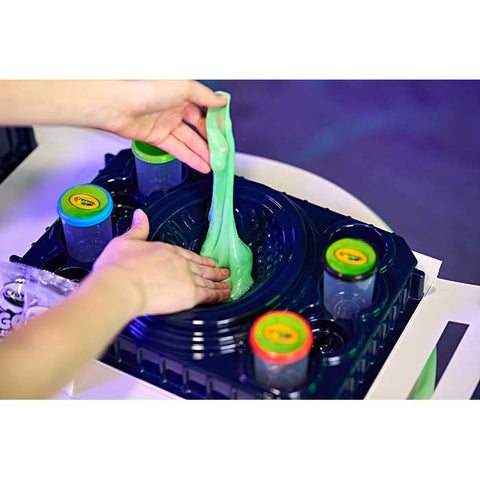 Child making galactic goo in the Crayola Goo sensory station