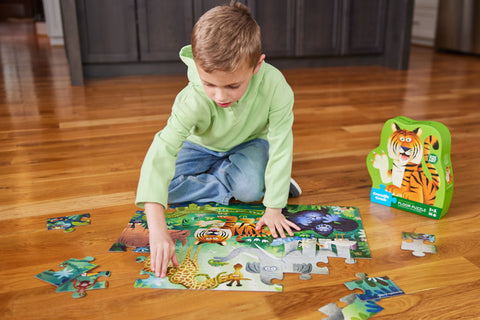 Crocodile Creek 36-piece Wild Kingdom floor puzzle with animals and child playing with it