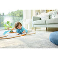 Child playing with the Hape Dual-Mode Space Shuttle on a wooden railway track set