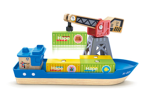 The Hape Cargo Ship & Crane is a vibrant wooden toy set featuring a blue cargo ship labeled "H-007" with stackable blocks displaying the Hape logo. Mounted on the ship is a magnetic crane holding a green container. The blocks, adorned with icons such as gifts and trucks, are designed to seamlessly integrate with Hape railway sets.