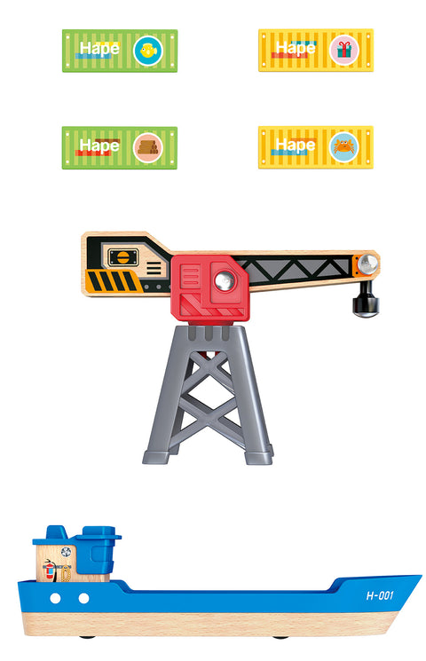 The Hape Cargo Ship & Crane by Hape features a gray and red wooden crane positioned above a blue cargo ship labeled "H-001." It includes four colorful pieces, two green and two yellow, marked with various goods symbols, all ready for loading. This set is designed to perfectly complement the Hape railway sets and includes a magnetic crane for seamless play.