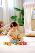 Child playing with the Hape Delightful Discovery Blocks