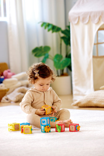 Child playing with the Hape Delightful Discovery Blocks