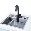 The Hape Deluxe Kitchen with Running Water shown from an angle, with the stovetop, oven and cupboard storage