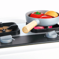 The light-up stovetop of the Hape Deluxe Kitchen with Running Water, which glows and plays cooking sounds during pretend play