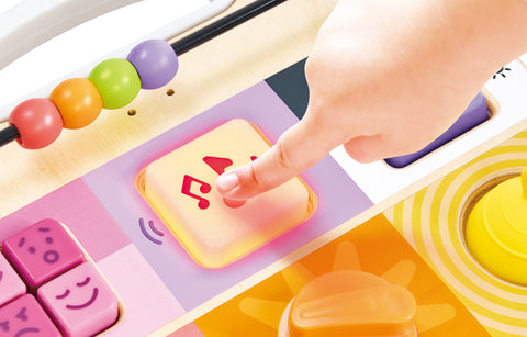 Baby playing with the Hape Explore & Learn Sensory Play Board