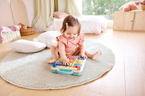 Detail of the wide wheelbase on the Hape Grow-With-Me Push Walker