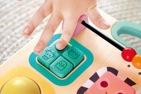 Hape Grow-With-Me Push Walker used as a seated play station