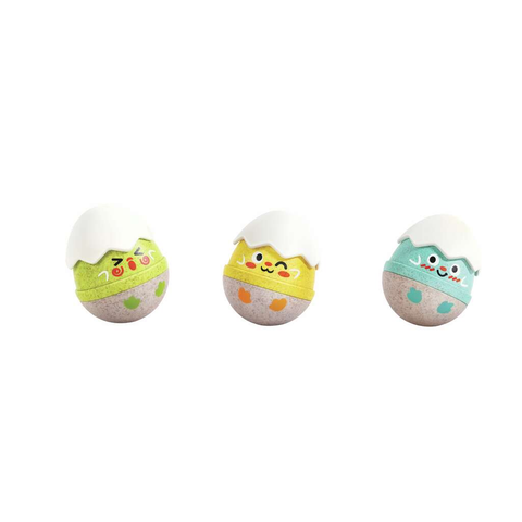 The three Hape Happy Hatchlings egg rattles shown together, each with a different happy facial expression.