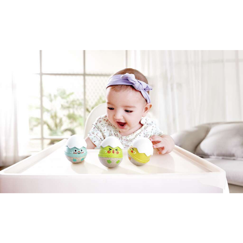 Close-up of a Hape Happy Hatchlings wobble rattle showing its soft silicone teether top and smiling face.