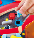 Child's hand interacting with Hape Little Racer's Busy Board