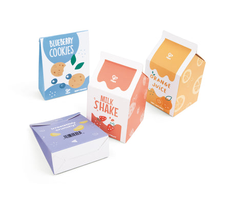 Assorted miniature food boxes including blueberry cookies, milkshake, and orange juice on a white background