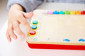 Child playing the Hape Pixelz Mini Piano