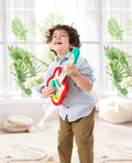 Child playing the Hape Pixelz Rainbow Rock Guitar