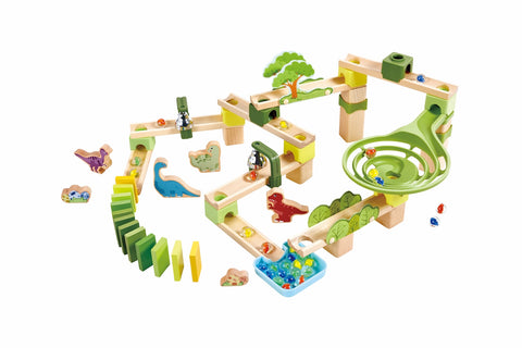 Wooden dinosaur marble run build showing spiral funnel, domino run, dinosaur figures and a marble collection tray