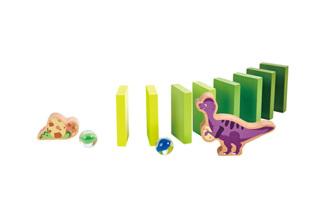 Wooden domino pieces toppling beside a fossil piece, marbles and a purple dinosaur figure