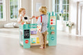 Two children playing with a Hape Smart Play Shop set in a bright room.