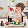 Child playing with a Hape Sushi Time Playset