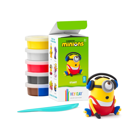 Contents of the Hey Clay Minions Stuart set laid out, with five tubs of soft air-dry clay in bright colours and a sculpting tool