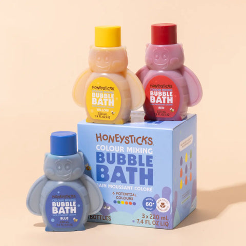 Three bottles of Honeysticks bubble bath with a box on a beige background