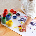 Child finger painting with Honeysticks Finger Paints