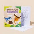 Honeysticks Toddler's First Colouring Book - Endangered Animals Adventure standing beside an open page showing an elephant outline with age and date fields