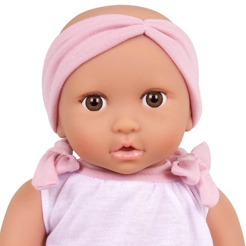 Close up of Lullababy doll with pink headband and outfit on a white background
