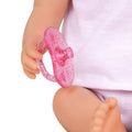 Close-up of a Lullababy doll's hand holding a pink pacifiier against a white background