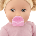 Close-up of a Lullababy doll with a pink pacifier and pink outfit on a white background