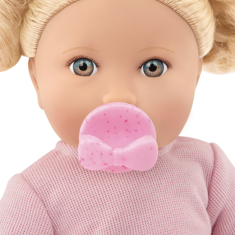 Close-up of a Lullababy doll with a pink pacifier and pink outfit on a white background