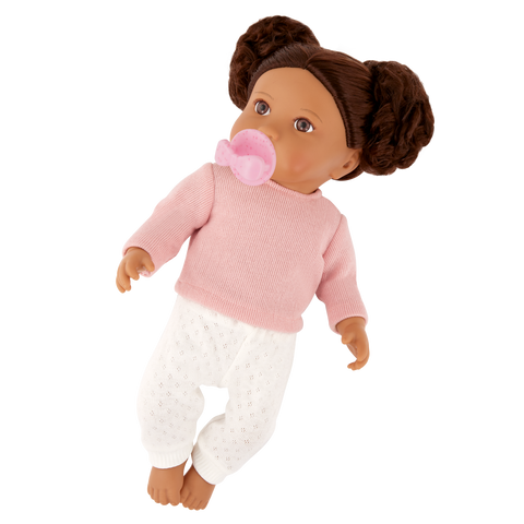 Lullababy 14" Doll wearing a pink sweater and white pants with a pacifier on a white background