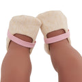 Close-up of a dark-skinned person wearing beige ballet pointe shoe covers with pink elastic bands, feet upside down, resembling the delicate grace of a Lullababy doll in a pink dress and shoes from the Lullababy 14" Outfit collection.