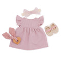The Lullababy 14" Outfit includes a charming pink dress for your Lullababy doll, featuring ruffled sleeves and a coordinating light pink bow headband. The ensemble is completed with beige doll shoes adorned with pink straps and a wooden heart-shaped teething toy wrapped in pink cloth, perfect for 35.5 cm dolls from the Lullababy brand.