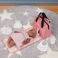 Lullababy doll with accessories on a star-patterned mat