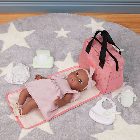 Lullababy doll with accessories on a star-patterned mat