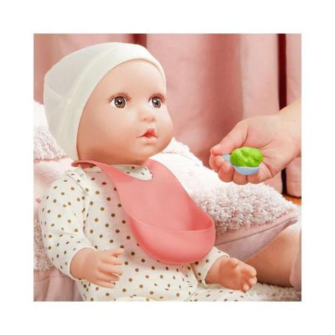 Lullababy doll with bib and diaper being fed by a hand holding a green toy food item.