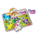 Melissa & Doug Unicorn Chunky Puzzle board with the blue, yellow, purple and white unicorn pieces in place, and the pink unicorn and rainbow pieces lifted out beside it