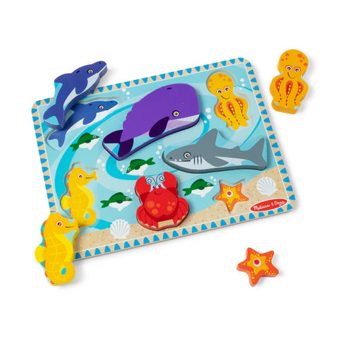 Melissa & Doug Sea Life Chunky Puzzle board with whale, shark, dolphin, seahorse and crab pieces in place, and the octopus and starfish pieces lifted out beside it