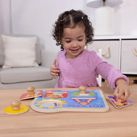 Child playing with a educational toy on a wooden table