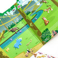 An open children's book from the Melissa & Doug Puffy Sticker Play Set - Safari displays a vibrant jungle scene with colorful illustrations of animals, including a blue rhinoceros, green crocodile, tiger, leopard, and various birds. A river weaves through the scene while tall trees adorned with vines and leaves encircle the animals, creating an exciting safari adventure.
