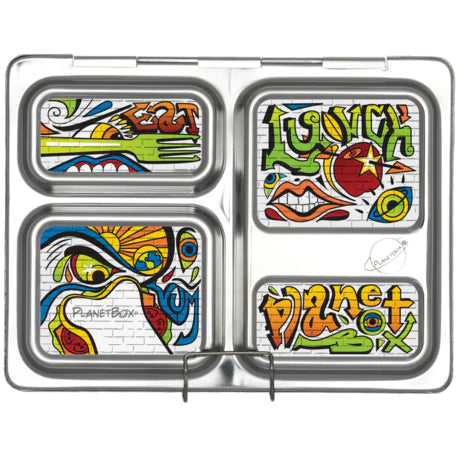 A silver rectangular lunchbox from CAMELBAK with four compartments, each decorated with colorful, graffiti-style artwork. The designs include bold and vibrant illustrations showcasing words like "lunch" and "PlanetBox" prominently. Pair it with PlanetBox Launch Magnet by CAMELBAK to create a unique look every day.