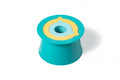 The QUUT Alto in Lagoon Green from QUUT is a silicone mold featuring a vibrant yellow and light blue ring design on top. It has a broad base that tapers towards a circular opening at the center, resembling a stackable toy. This mold is ideal for crafting ring-shaped confections or other foods.