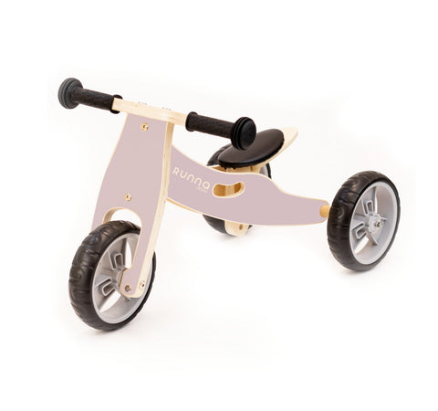 A close-up of the Runna Mini - Dusty Pink by RUNNA reveals its sturdy construction and vibrant colors, perfect for little ones making the transition from a balance bike.
