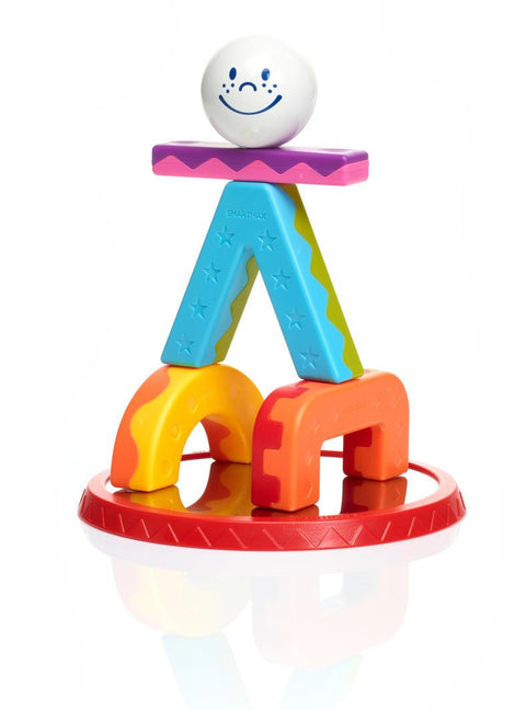 The SmartMax My First Acrobats is a vibrant stacking toy adorned with star and zigzag patterns, showcasing a white textured ball with a smiling face on top. 