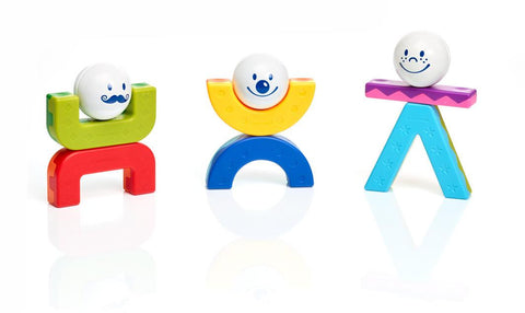 Three colorful toy figures from the SmartMax My First Acrobats set stand on a white surface. 